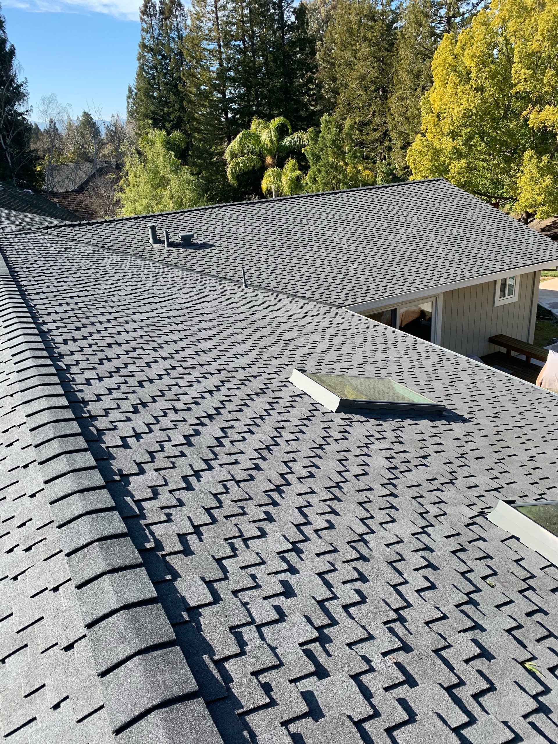 Newly installed gray asphalt shingle roof